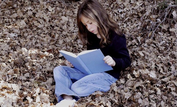 Little girl reading a book 