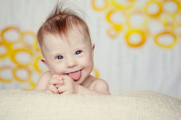 Baby with tongue out smiling at camera