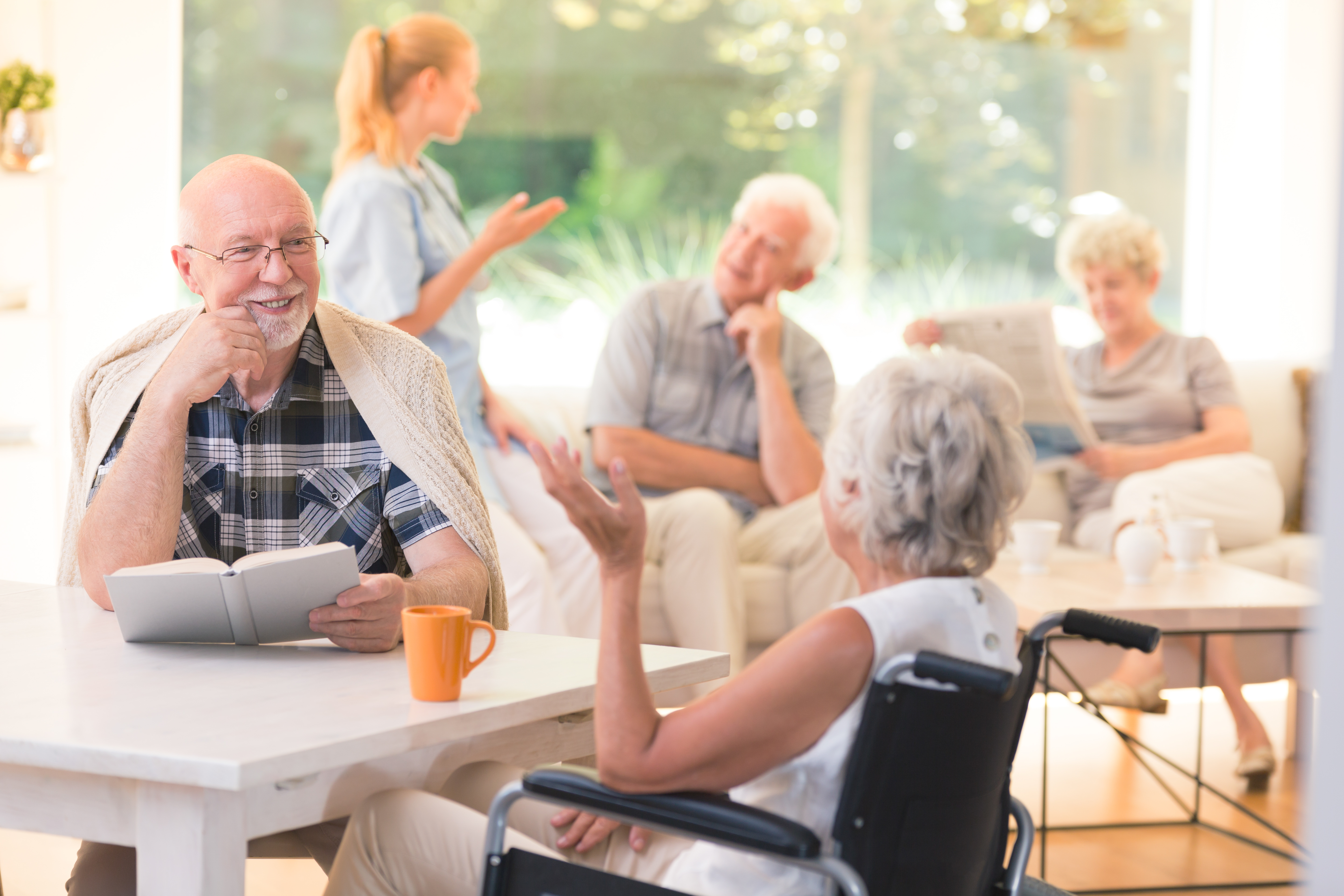 2018.12.04 Stock Photo Inside Retirement Home Happy elderly people being social and having a conversation 001