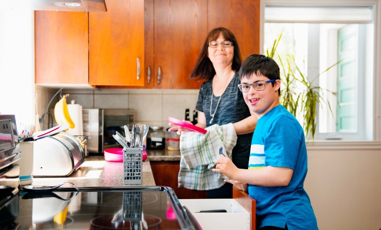 mother helping her son with disability to do housework