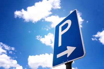 Blue sky with white clouds, a parking sign