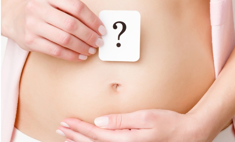 woman showing question mark on naked belly 