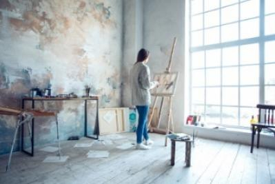 Young woman artist painting