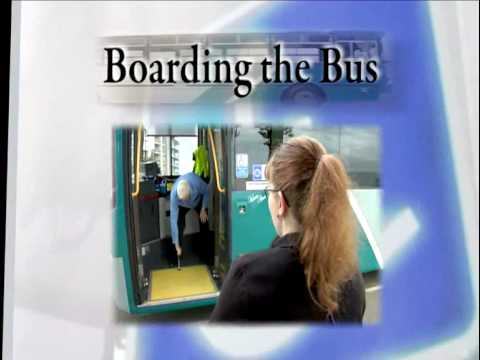 Boarding the bus and a lady in a wheelchair ready to board a bus