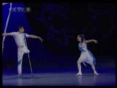 Man without a leg and woman without an arm on stage performing ballet