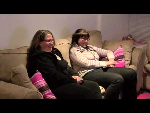 2 ladies sitting on the lounge laughing