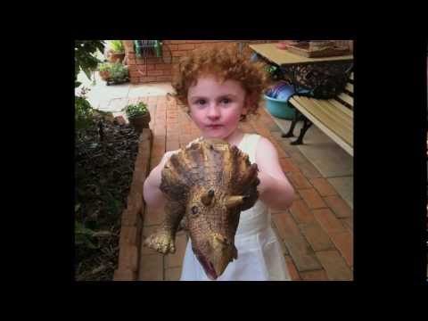 Little girl holding a dinosaur toy