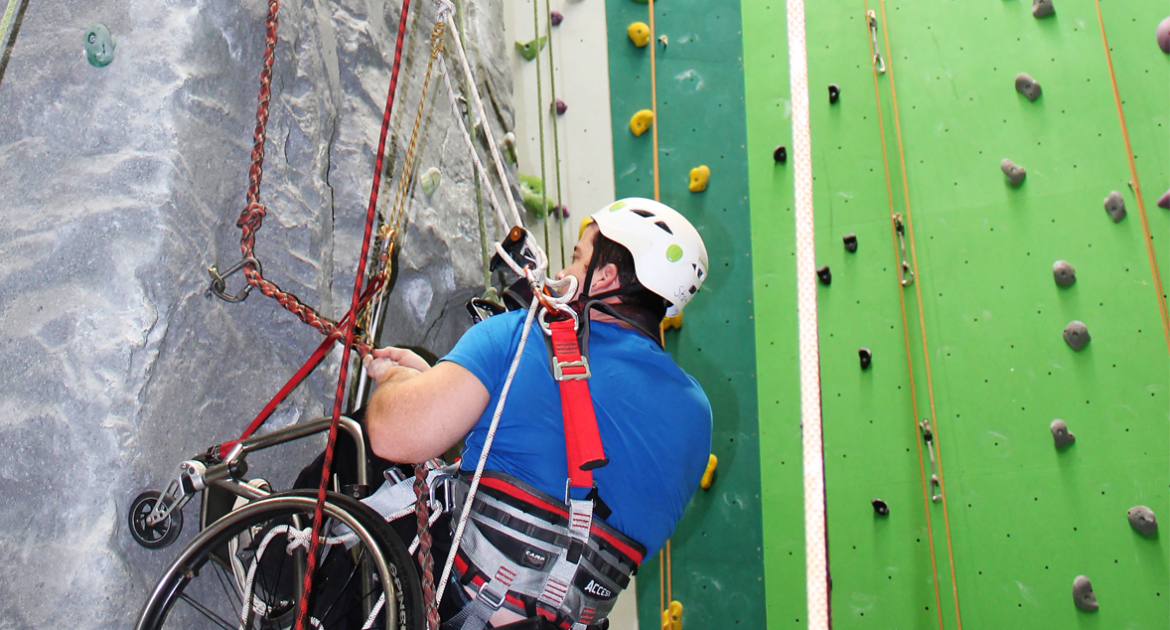 person participating in adaptive rock climbing