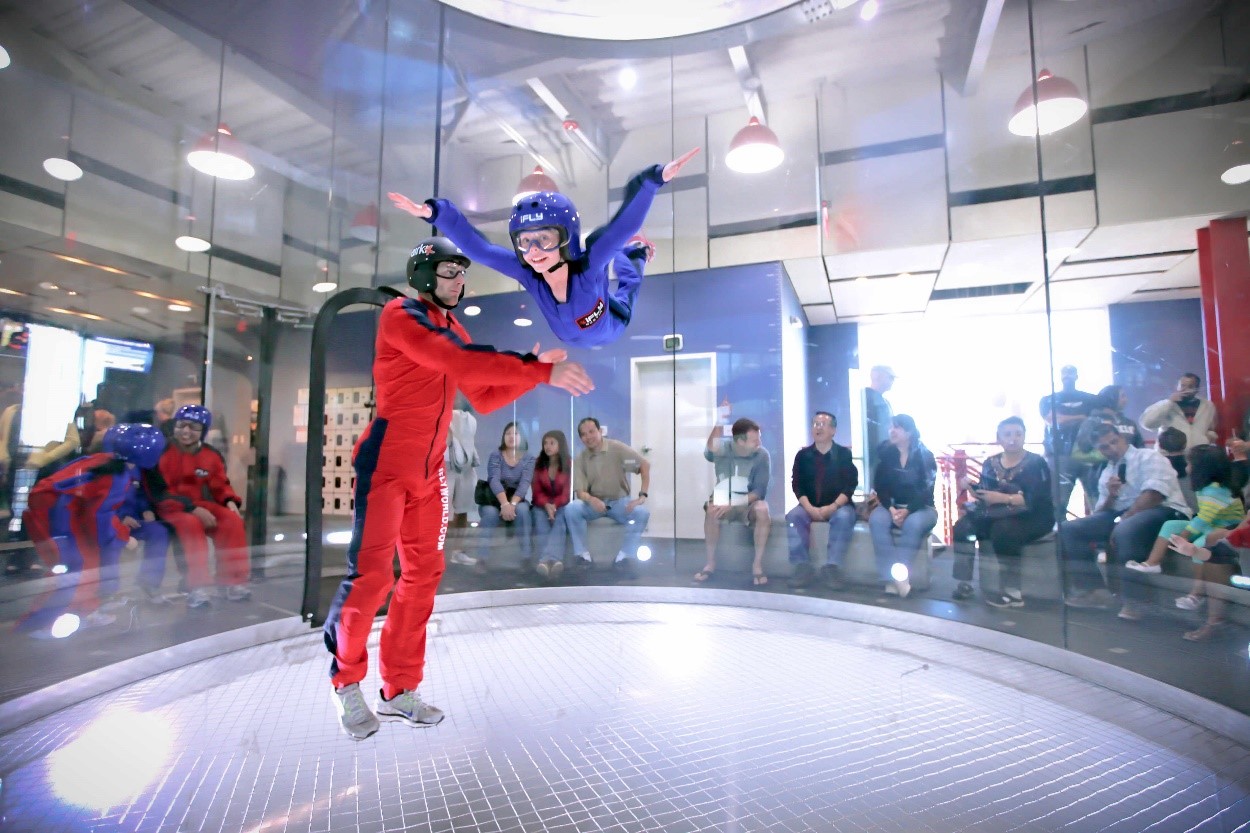 A person participating in indoor skydiving