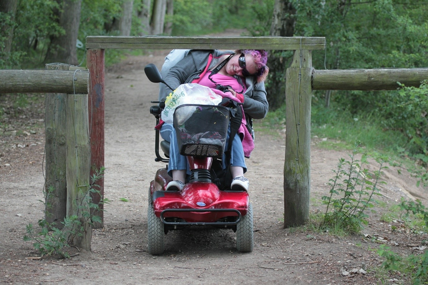 Lady travels on electric scooter on a bush trail
